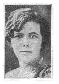 Black and white grainy photo of a unsmiling woman with short dark hair.