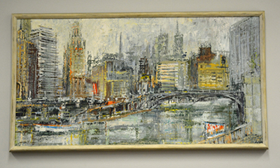 Oil painting of the Chicago River hung up on a tan wall