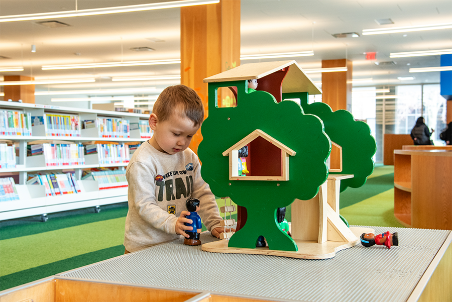 Young boy playing with figures in the Kids Room