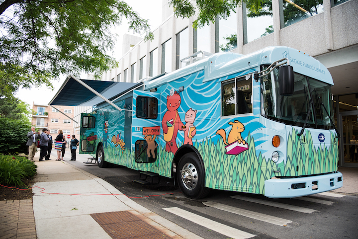 Image of the library's newest Bookmobile with a colorful wrap-around character design