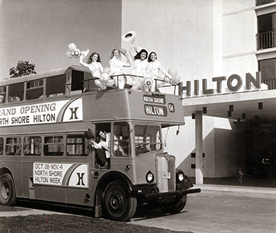 Double-decker bus in front of Hilton hotel entrance