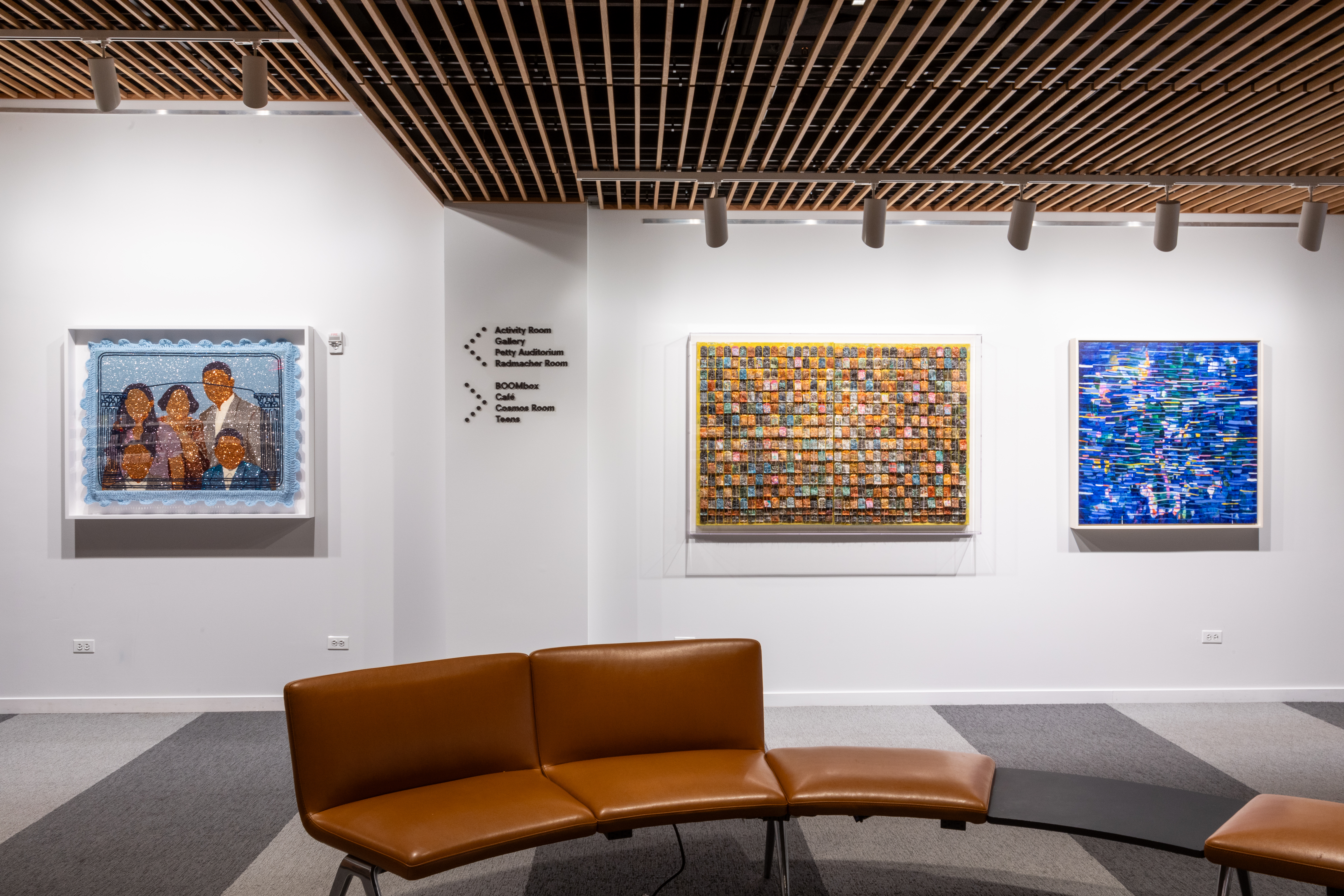 Three art pieces hanging on a wall