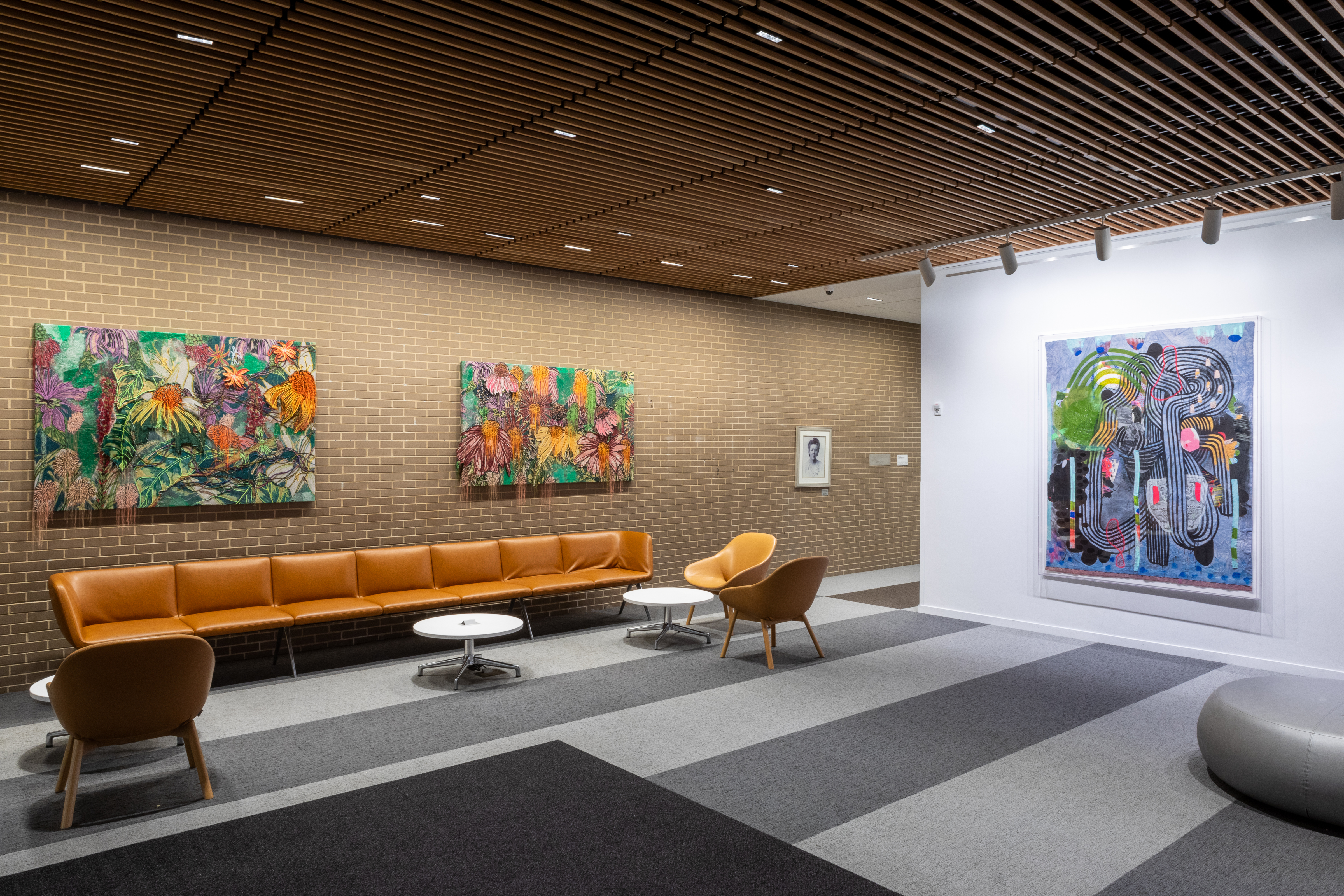 Three art pieces hanging on a wall