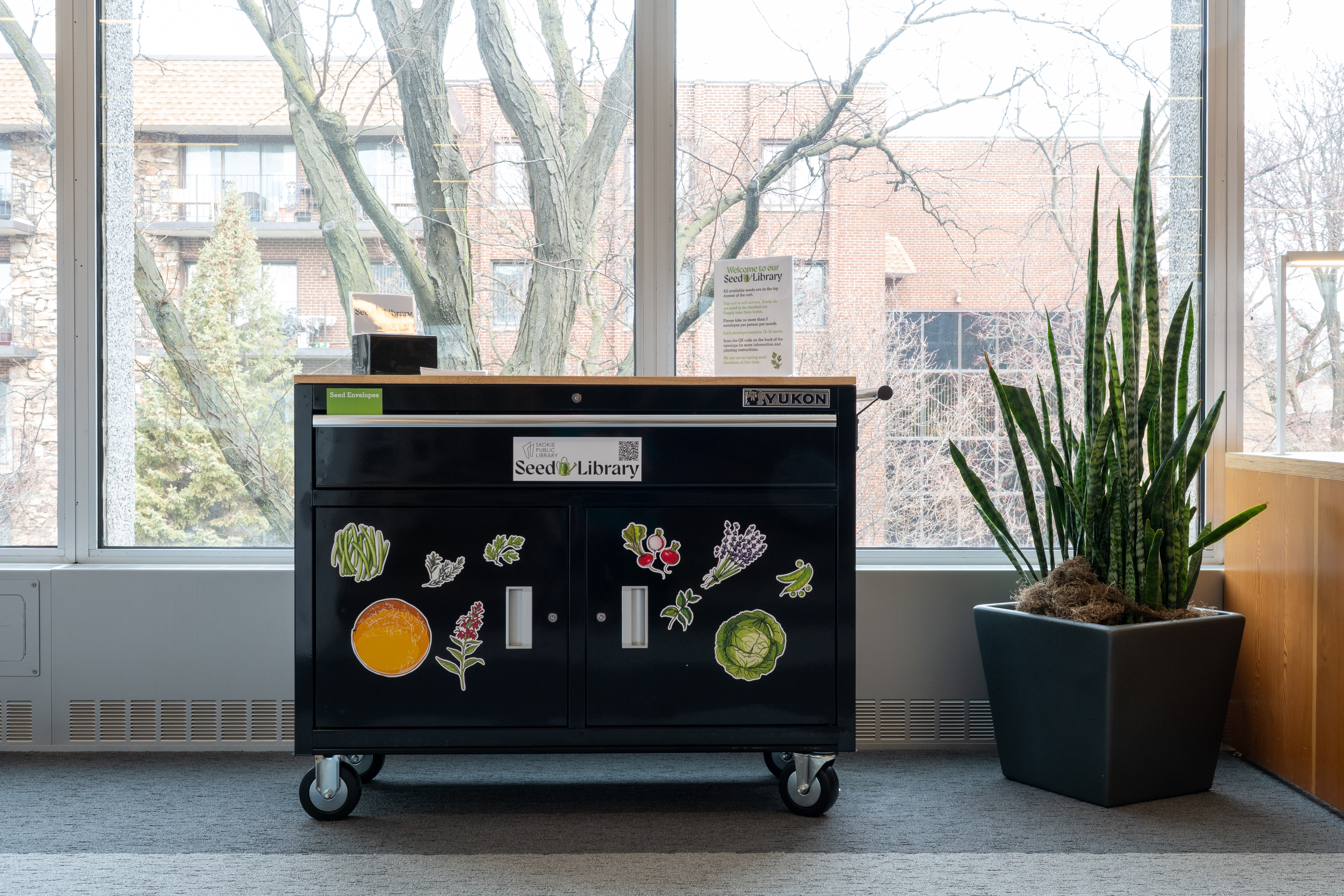 cart in the library. There are magnets of vegetables decorated on it. 