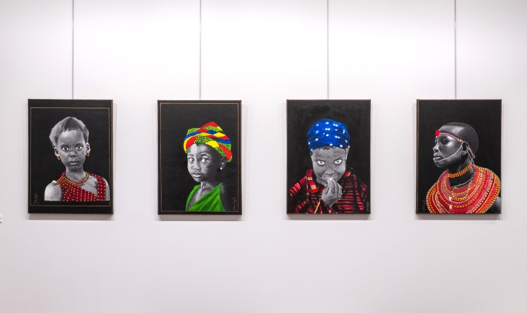 Four charcoal paintings on a wall