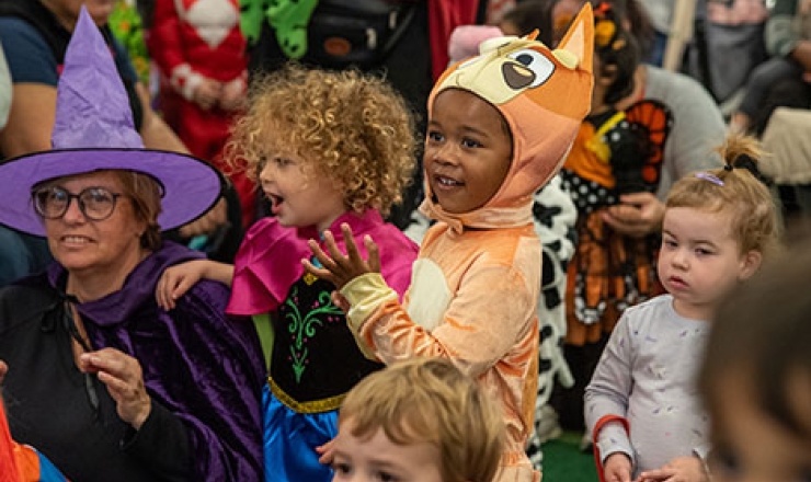 group of children and some adults wearing Halloween costumes