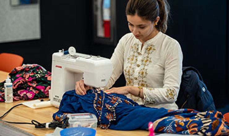 a woman sewing at a sewing machine