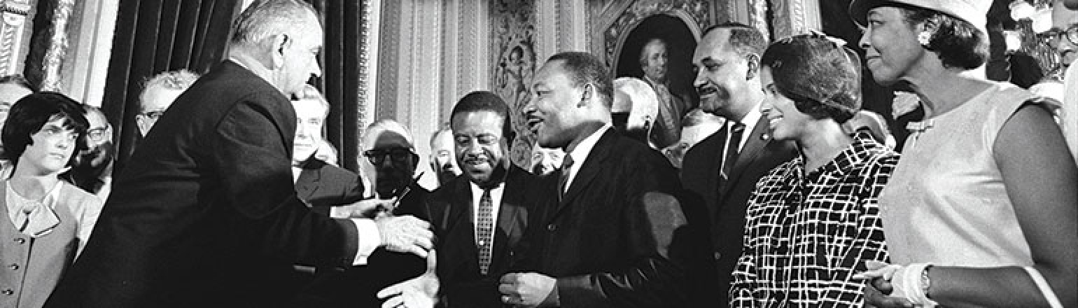 black and white photo of Martin Luther King Jr and others meeting with President Lyndon 