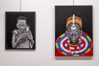 two charcoal paintings on a wall