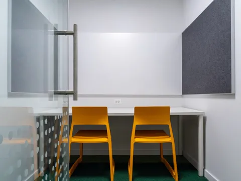 Study Room with table, chairs, and a whiteboard. 