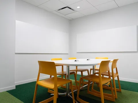 Study Room with table, chairs, and two whiteboards. 