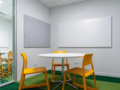 Study Room with table, chairs, and two whiteboards. 