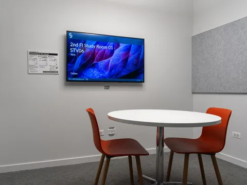 Study Room with table, chairs, and a display screen.