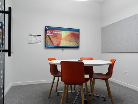 Study Room with table, chairs, and a display screen.