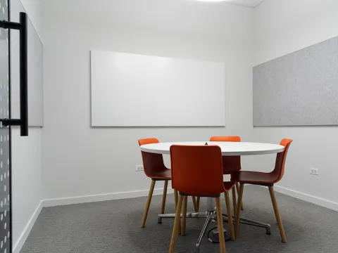 Study Room with table, chairs, and a whiteboard.