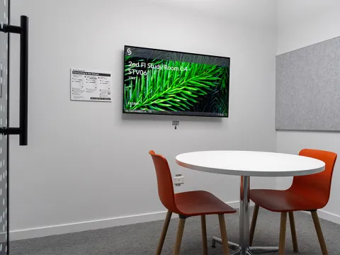 Study Room with table, chairs, and a display screen.