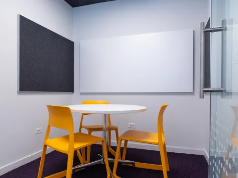 Study Room with table, chairs, and a whiteboard. 