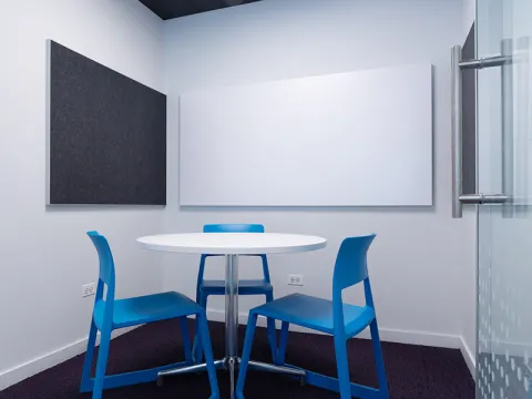 Study Room with table, chairs, and a whiteboard. 
