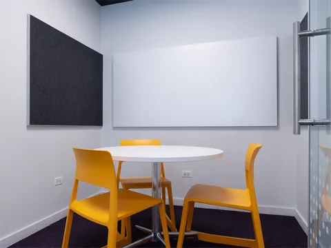 Study Room with table, chairs, and a whiteboard. 