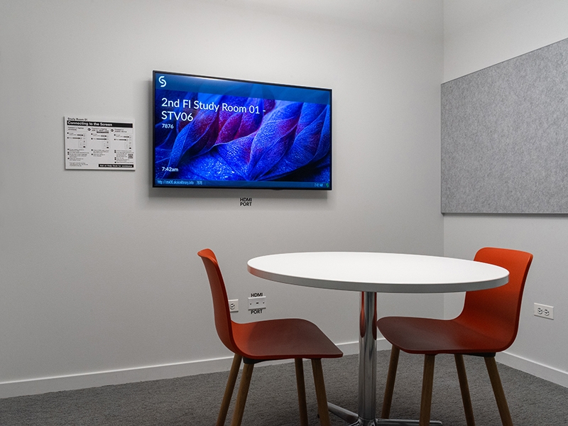 Study Room with table, chairs, and a display screen.