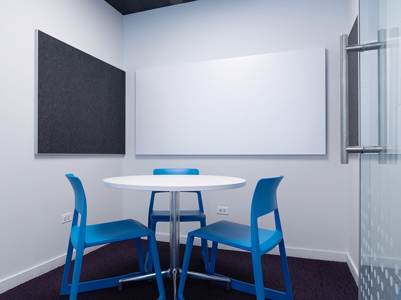 Study Room with table, chairs, and a whiteboard. 