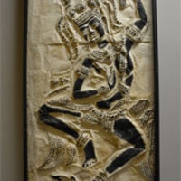 Black and white image made in the style of a stone rubbing. Depicts a dancing figure.