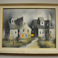 Painting of farm houses in a gold frame