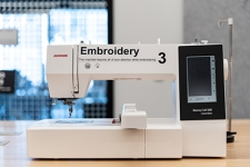 Embroidery machine sitting on a wooden table