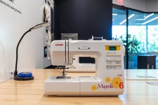 Sewing Machine sitting on top of a wooden table