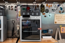 view of a 3D printer surrounded by items that were 3D printed.